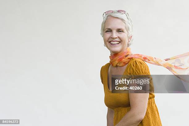 portrait of a mature woman smiling - neckerchief stock pictures, royalty-free photos & images