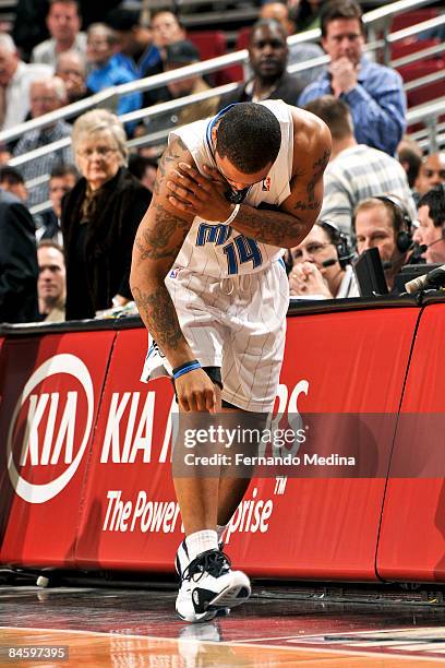 Jameer Nelson of the Orlando Magic holds his shoulder as he heads off the court after hurting it during the game against the Dallas Mavericks on...