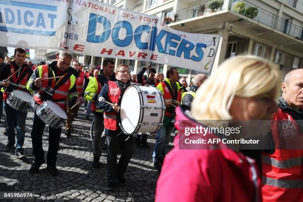 Demonstrators take part in a protest called by several French unions against the labour law reform at the harbour of Le Havre on September 12, 2017....