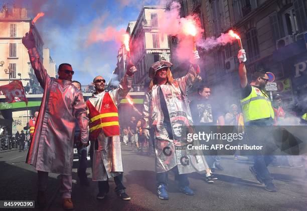 ArcelorMittal's workers hold flares during a protest called by several French unions against the labour law reform in Marseille, southern France, on...