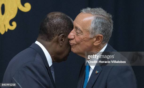 The President of Ivory Coast Alassane Dramane Ouattara embraces with Portuguese President Marcelo Rebelo de Sousa during the press conference at the...