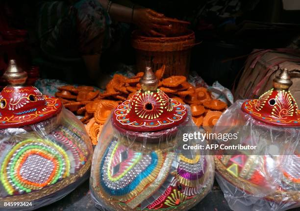 An Indian potter prepares traditional decorative earthen pots ahead of the Hindu festival of Navaratri, at the Kumbharwada potters colony in Mumbai...