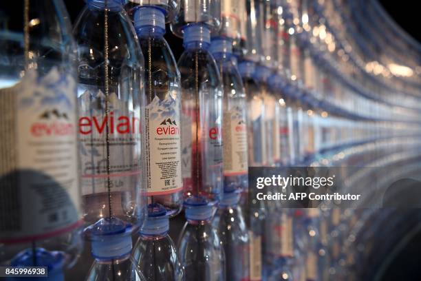 Picture taken in Amphion-les-Bains, near Evian, French Alps, on september 12, 2017 shows a line of bottles during the inauguration of Evian mineral...