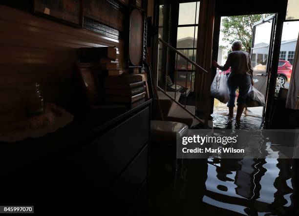 Carolyn Cole removes her belongings from her home that was flooded by Hurricane Irma on September 12, 2017 in Bonita Springs, Florida. On Sunday...