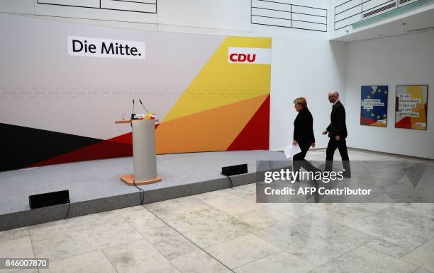 German Chancellor Angela Merkel is accompanied by CDU secretary general Peter Tauber as she arrives to give a statement on September 12, 2017 in...