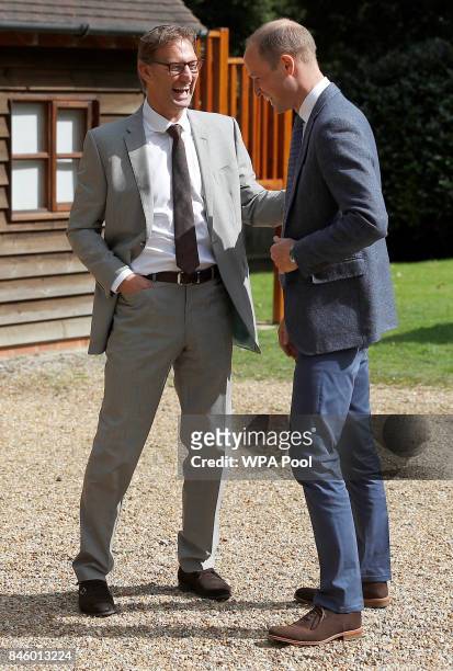 Britain's Prince William, Duke of Cambridge speaks with former footballer and founder of the charity Sporting Chances, Tony Adams at the residential...