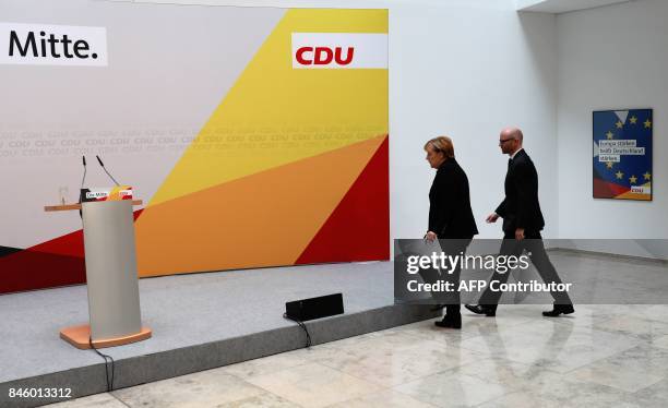 German Chancellor Angela Merkel is accompanied by CDU secretary general Peter Tauber as she arrives to give a statement on September 12, 2017 in...