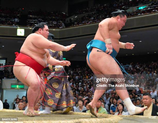 Onosho sends Mongolian komusubi Tamawashi out of the ring to win during day three of the Grand Sumo Autumn Tournament at Ryogoku Kokugikan on...