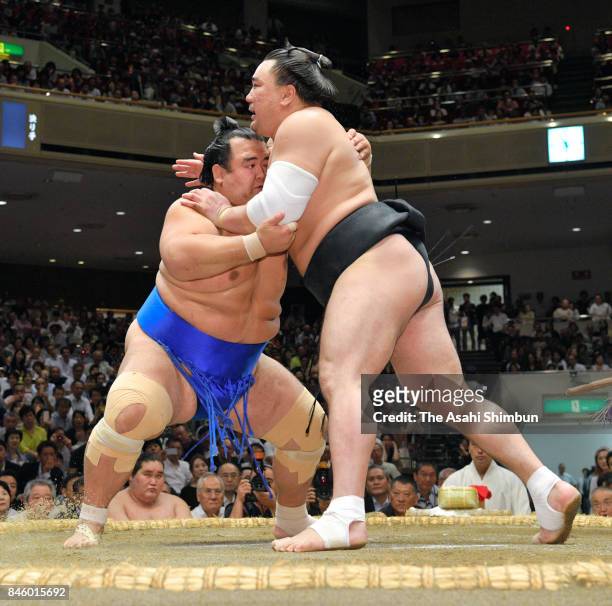 Mongolian yokozuna Harumafuji and Kotoshogiku compete during day three of the Grand Sumo Autumn Tournament at Ryogoku Kokugikan on September 12, 2017...