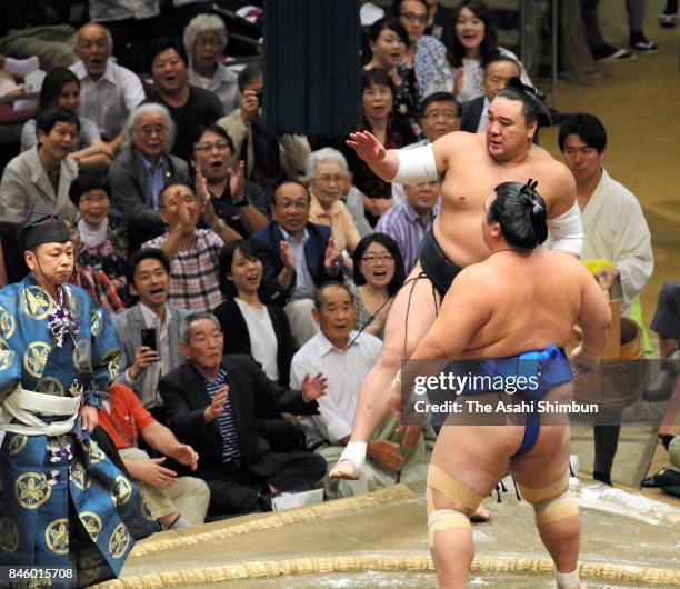 Mongolian yokozuna Harumafuji reacts after his defeat by Kotoshogiku during day three of the Grand Sumo Autumn Tournament at Ryogoku Kokugikan on...