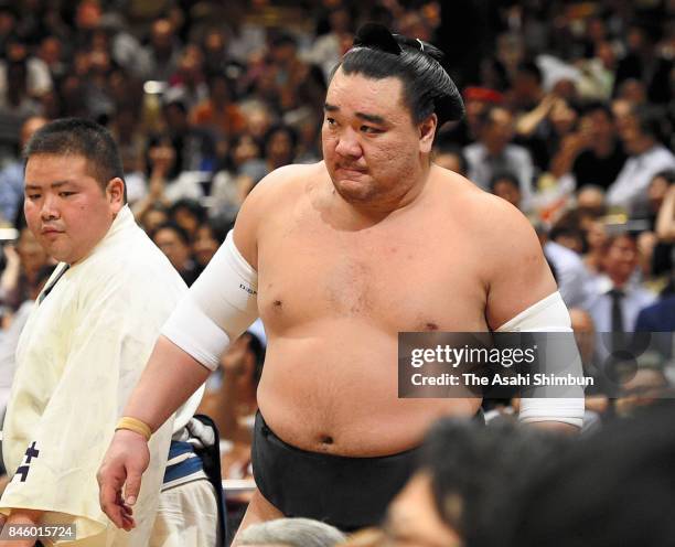 Mongolian yokozuna Harumafuji reacts after his defeat by Kotoshogiku during day three of the Grand Sumo Autumn Tournament at Ryogoku Kokugikan on...