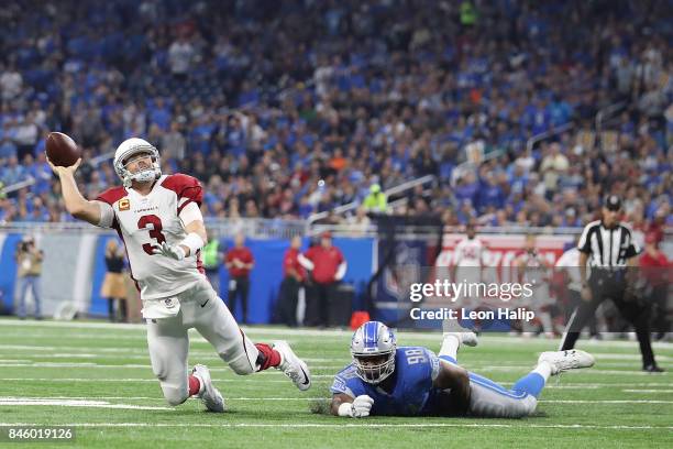 Jeremiah Ledbetter of the Detroit Lions attempts to tackle Carson Palmer of the Arizona Cardinals in the first half at Ford Field on September 10,...