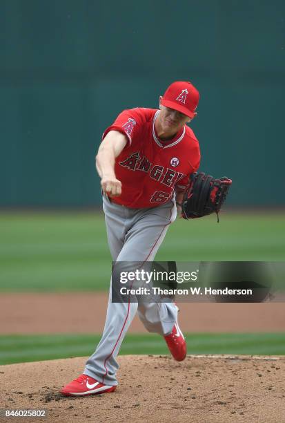 Parker Bridwell of the Los Angeles Angels of Anaheim pitches against the Oakland Athletics in the bottom of the first inning at Oakland Alameda...