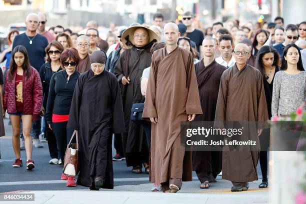 Brother Phap Luu and 50 of the Thich Nhat Hanh's global monastic community lead a silent peace walk at La Cienega Park before the 'Walk With Me'...