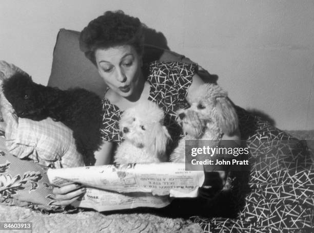 British actress and singer Betty Driver with the three pet poodles, Jackie, Mitzi and Tina, which feature on her TV show, circa 1950.