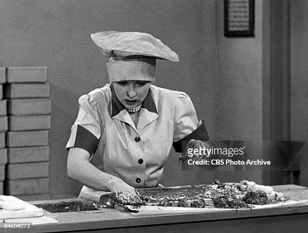 American comedienne and actress Lucille Ball , as Lucy Ricardo, works in a candy factory on an episode of the television comedy 'I Love Lucy'...