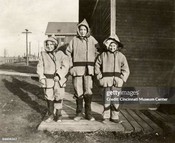 Children pose outside a tuberculosis sanatorium facility while dressed in heavy winter attire, Cincinnati, Ohio, 1915.