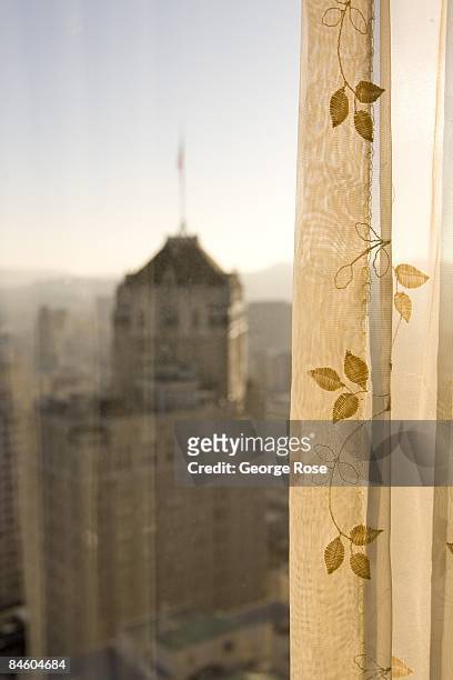 The Mark Hopkins Hotel is seen through a Fairmont Hotel room curtain in this 2009 San Francisco, California, late afternoon cityscape photo taken...