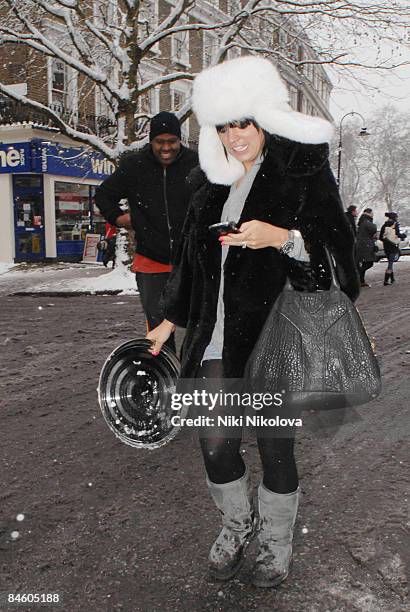Lily Allen uses her phone while out in the snow in Primrose Hill on February 2, 2009 in London, England.