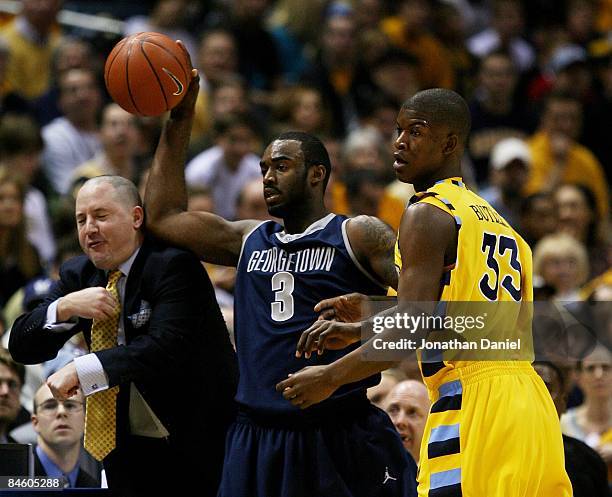 DaJuan Summers of the Georgetown Hoyas hits head coach Buzz Williams of the Marquette Golden Eagles in the head as Summers and Jimmy Butler look to...