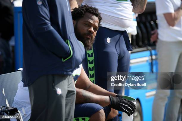 Michael Bennett of the Seattle Seahawks sits on the bench during the national anthem prior to the game against the Green Bay Packers at Lambeau Field...