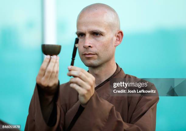 Brother Phap Luu invites the bell during the silent peace walk led by the Thich Nhat Hanh's global monastic community before the 'Walk With Me'...