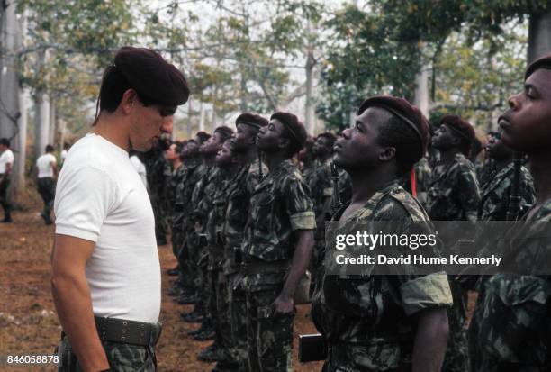 Colonial Portuguese soldier inspects cadets, during the Mozambican War of Independence, Ancuabe, Cabo Delgado Province, Mozambique, July 27, 1973....