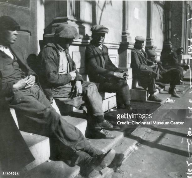 Unemployed men sit outside waiting dinner at Robinson's soup kitchen located at 9th and Plum streets, Cincinnati, Ohio, 1931.