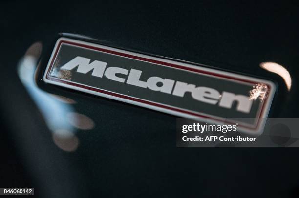 McLaren badge is seen on the bonnet of a car in a show room at the McLaren Technology Centre in Woking, west of London on September 12 during...