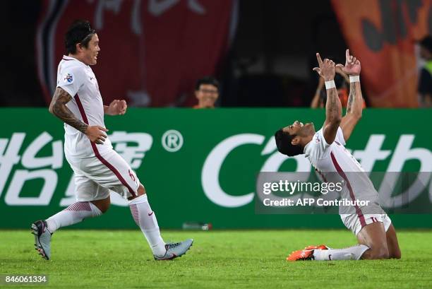 Shanghai SIPG's Hulk celerates after scoring a goal during their AFC Champions League quarter-final football match against Guangzhou Evergrande in...