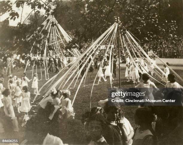 Young girls and children dance around the May poles during May Day celebrations, Cincinnati, 1921.