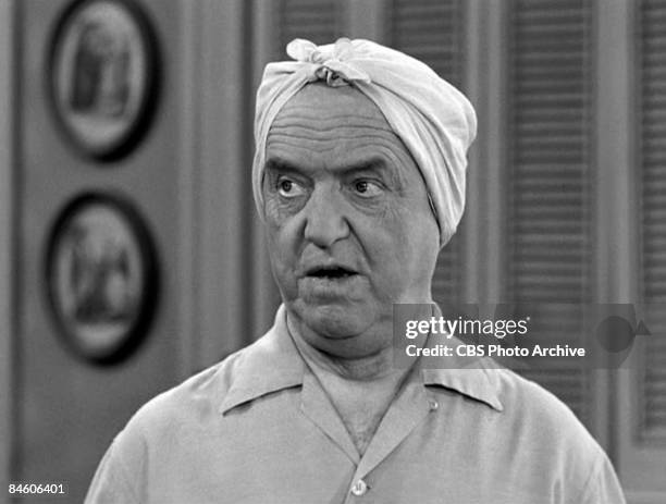 CLose-up of American actor William Frawley , as Fred Mertz, wears a scarf on his head in a scene from an episode of the television comedy 'I Love...