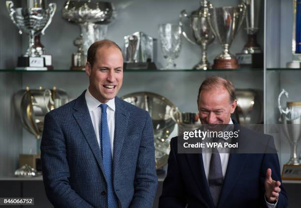 Prince William, Duke of Cambridge talks with Mike Flewitt , CEO of McLaren Automative in front of a trophy cabinet for McLaren racing sports...