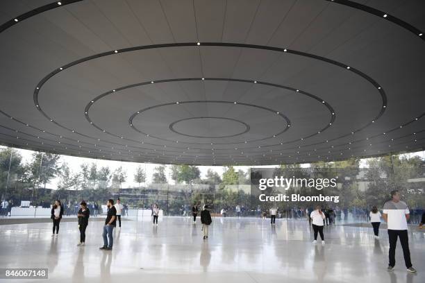 Apple Inc. Employees stand as attendees arrive ahead of an event at the Steve Jobs Theater in Cupertino, California, U.S., on Tuesday, Sept. 12,...