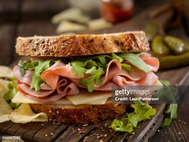 ham, swiss and arugula sandwich - cold cuts stock pictures, royalty-free photos & images