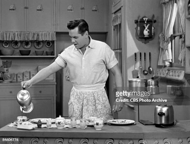 Cuban-born American actor and musician Desi Arnaz , as Ricky Ricardo, pours a cup of coffee in the kithcen in a scene from an episode of the...