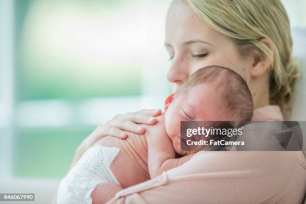 Mother Rocking Baby To Sleep Photos and Premium High Res Pictures ...