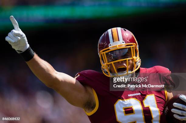 Ryan Kerrigan of the Washington Redskins celebrates after running an interception back for a touchdown in the first half against the Philadelphia...