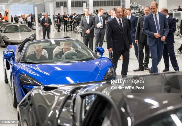 Prince William, Duke of Cambridge speaks with employees on the McLaren commercial vehicle production line as he walks the factory floor during a...