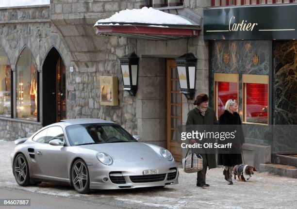 Couple walk past a jewelery store in the town centre of St Moritz, Switzerland on January 30, 2009. The affluent ski resort of St Moritz in the Swiss...
