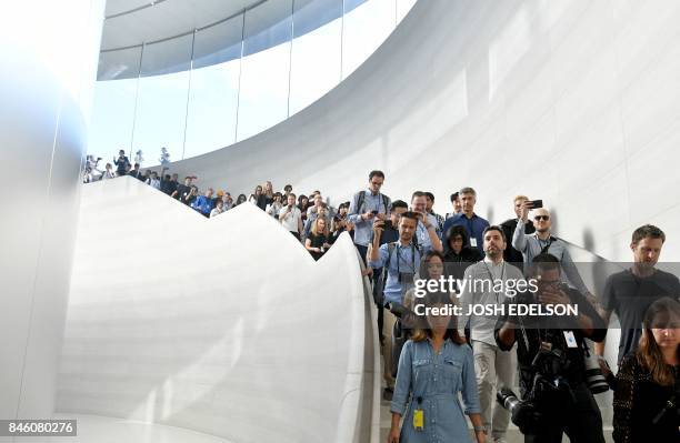 Members of the media enter the Steve Jobs Theater at Apple's new headquarters ahead of a media event where Apple is expected to announce a new iPhone...