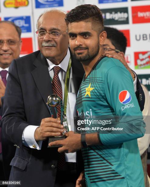 Pakistani cricketer Babar Azam receives man of the match award from Chairman Pakistan Cricket Board Najam Sethi during a ceremony at the end of the...
