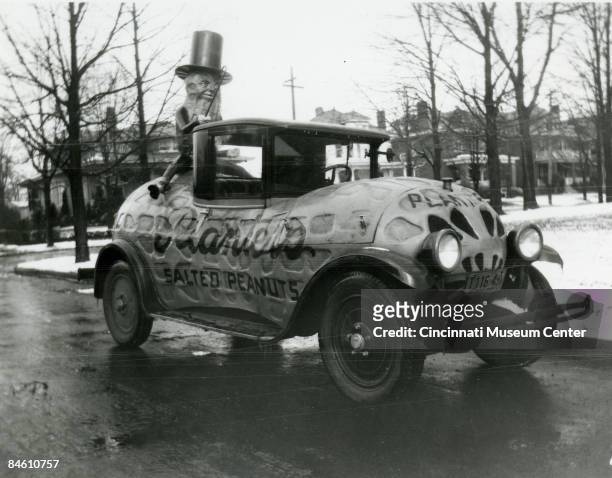 The Planter's Peanut automobile, modified into a peanut shape and bearing the mascot in the rear, travels through the College Hill neighborhood near...