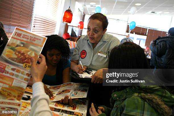 Denny's waitress Hirut Bizuneh takes an order for free Grand Slam breakfasts February 3, 2009 in Emeryville, California. People lined up at Denny's...