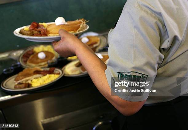 Denny's waitress Hirut Bizuneh prepares to deliver free Grand Slam breakfasts to customers February 3, 2009 in Emeryville, California. People lined...