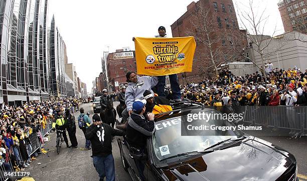 Ryan Clark of the Pittsburgh Steelers sands on top of his truck with a Terrible Towel during a parade to celebrate winning Super Bowl XLIII on...