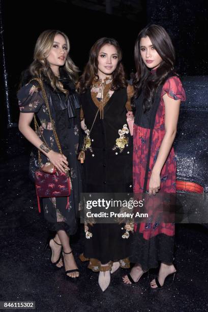 Cinta Laura, Fazura, and Praiya Soandokmai attend Coach Spring 2018 fashion show during New York Fashion Week at Basketball City - Pier 36 - South...