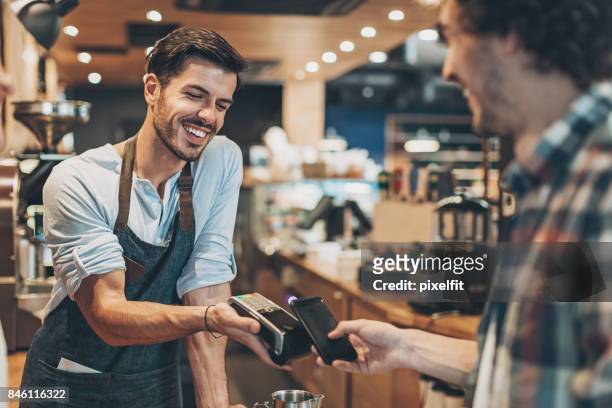 fast and easy payment in the coffee shop - contactless payment stock pictures, royalty-free photos & images