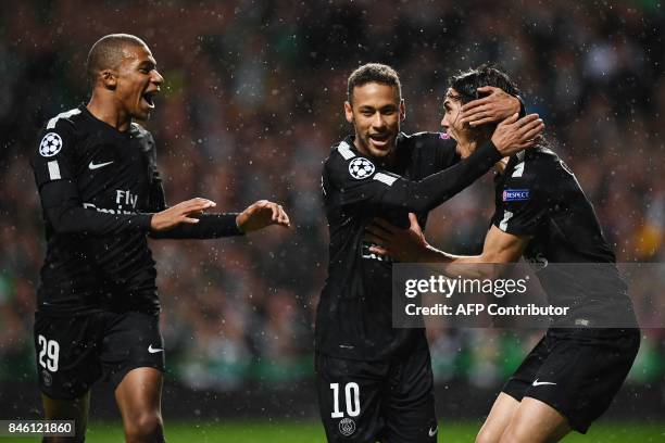 Paris Saint-Germain's Brazilian striker Neymar celebrates with Paris Saint-Germain's French striker Kylian Mbappe and Paris Saint-Germain's Uruguayan...