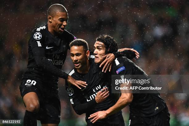 Paris Saint-Germain's Brazilian striker Neymar celebrates with Paris Saint-Germain's French striker Kylian Mbappe and Paris Saint-Germain's Uruguayan...